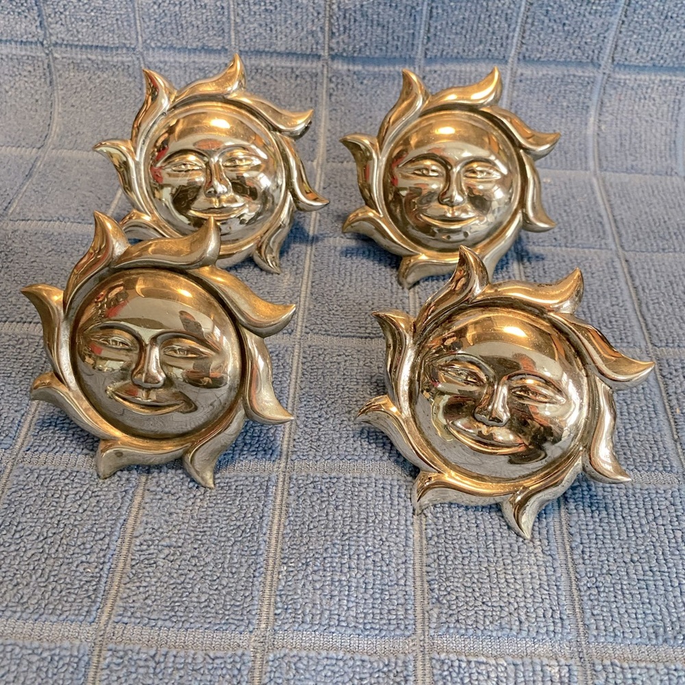 Vintage set of 4 silver plated napkin holders by Elegance. Celestial sun faces.